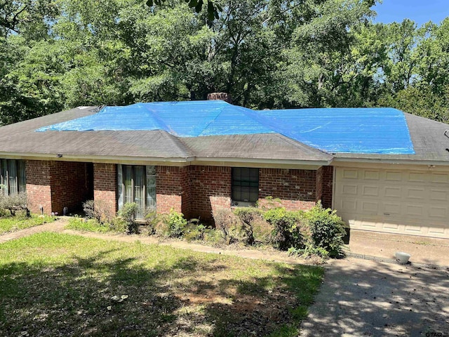 712 Leon Dr, Tyler, TX 75702 - single story home featuring brick siding, a chimney, and an attached garage