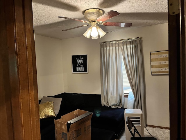712 Leon Dr, Tyler, TX 75702 - sitting room featuring ceiling fan, a textured ceiling, and carpet