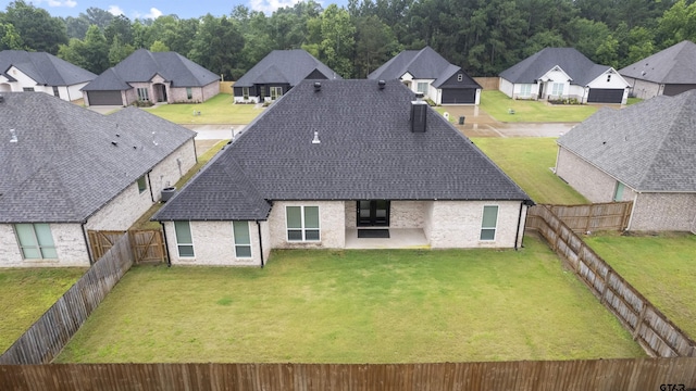11918 Gillian Ct, Tyler, TX 75703 - rear view of house featuring a residential view, brick siding, a patio area, and roof with shingles
