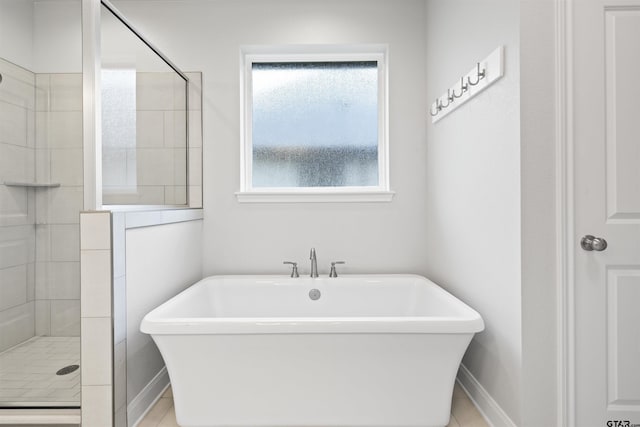 11918 Gillian Ct, Tyler, TX 75703 - full bath featuring a freestanding tub, tiled shower, and baseboards