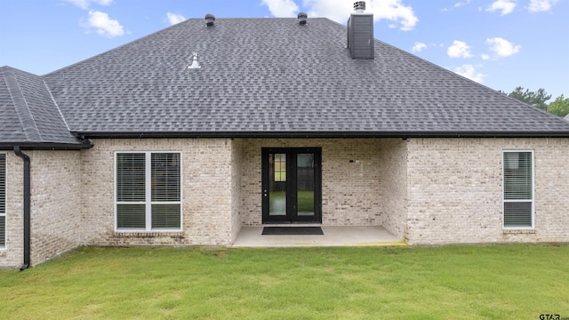 11918 Gillian Ct, Tyler, TX 75703 - rear view of house with roof with shingles, a chimney, a yard, and a patio