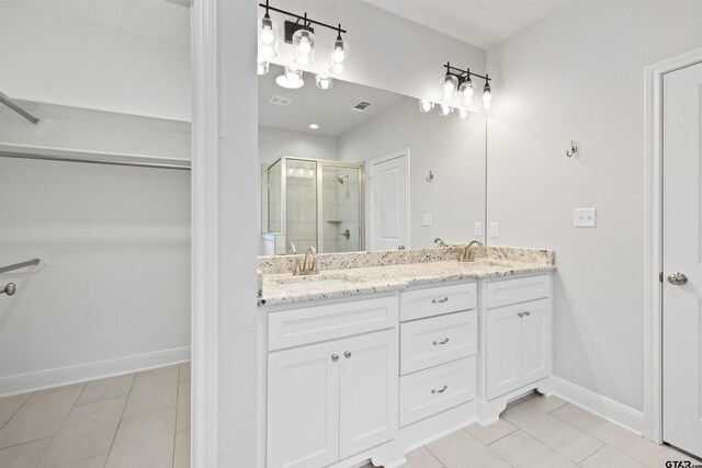 11918 Gillian Ct, Tyler, TX 75703 - full bathroom featuring a stall shower, tile patterned flooring, double vanity, and baseboards