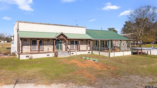 view of front of home with a porch and a front lawn