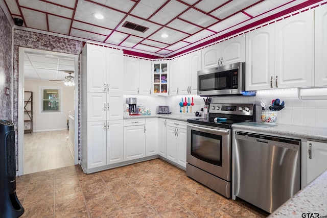 kitchen featuring backsplash, ceiling fan, white cabinetry, and stainless steel appliances