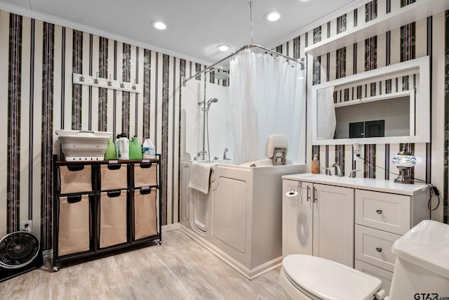 bathroom featuring hardwood / wood-style floors, sink, crown molding, toilet, and curtained shower