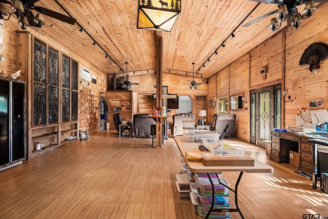 interior space with rail lighting, wood ceiling, ceiling fan, wooden walls, and beamed ceiling