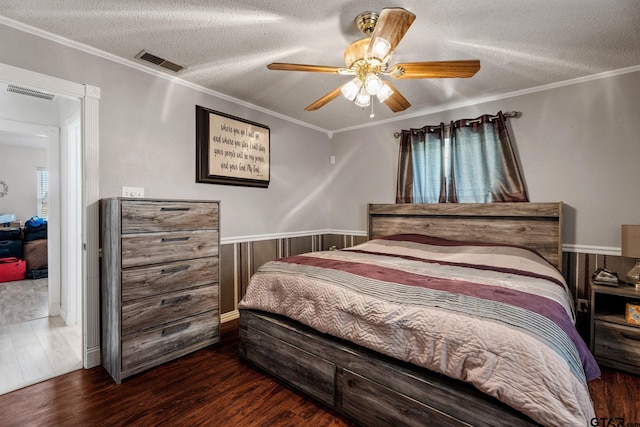 bedroom featuring ceiling fan, crown molding, and a textured ceiling