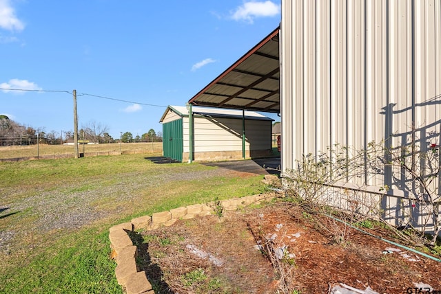 view of yard featuring an outdoor structure and a carport