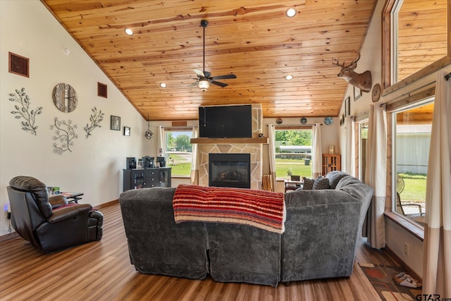 111 Little River Bnd, Quitman, TX 75783 - living area with a healthy amount of sunlight, a stone fireplace, lofted ceiling, and wood ceiling