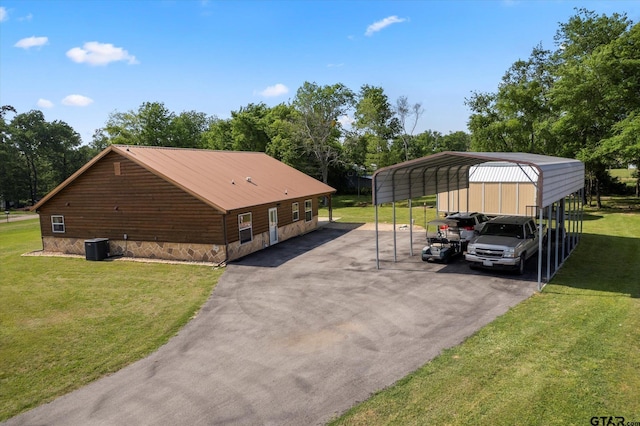 111 Little River Bnd, Quitman, TX 75783 - exterior space featuring a lawn, a detached carport, central AC, and aphalt driveway