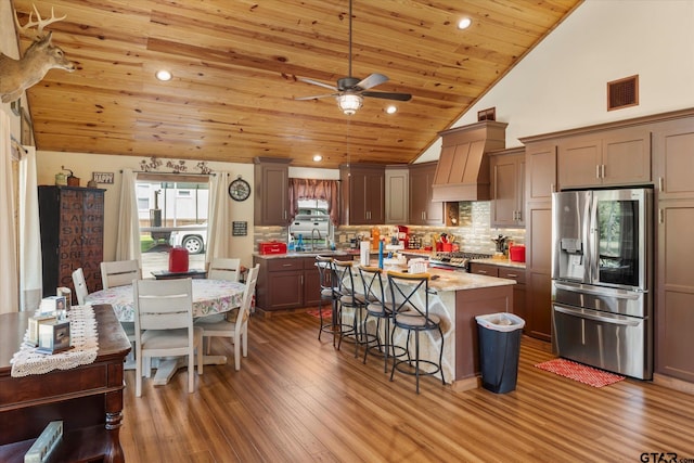 111 Little River Bnd, Quitman, TX 75783 - kitchen featuring wooden ceiling, custom exhaust hood, stainless steel appliances, a sink, and visible vents