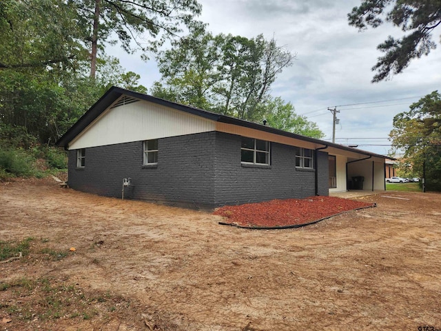 view of side of home featuring a carport