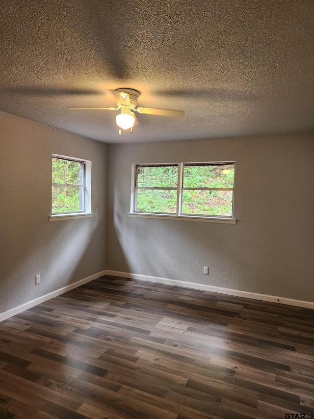 unfurnished room featuring ceiling fan, dark hardwood / wood-style flooring, and a textured ceiling