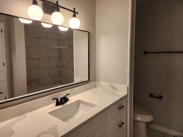 bathroom featuring tile patterned floors, vanity, and toilet