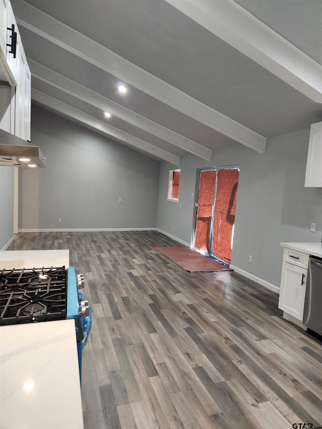 kitchen with beamed ceiling, white cabinets, stainless steel dishwasher, and hardwood / wood-style flooring