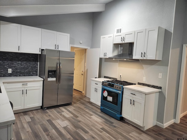 kitchen featuring white cabinetry, stainless steel fridge with ice dispenser, ventilation hood, range with gas stovetop, and lofted ceiling