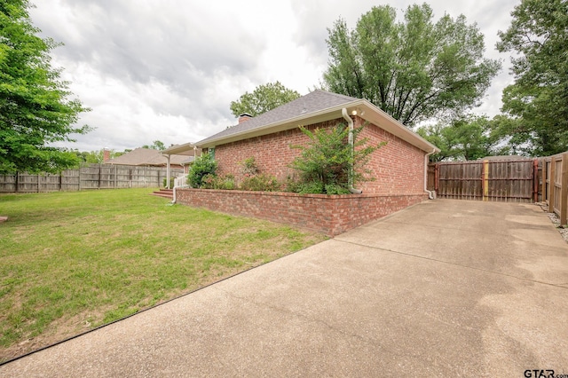 5607 Bostick Dr, Tyler, TX 75707 - view of home's exterior featuring brick siding, a patio area, and a chimney