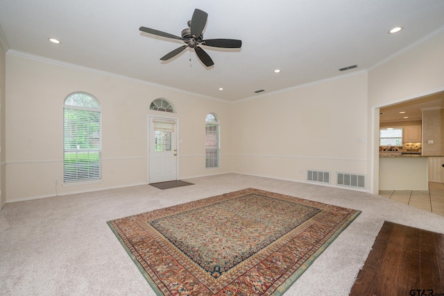 5607 Bostick Dr, Tyler, TX 75707 - entryway with light colored carpet, recessed lighting, healthy amount of natural light, crown molding, and ceiling fan