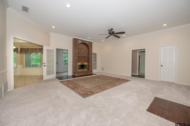 5607 Bostick Dr, Tyler, TX 75707 - unfurnished living room with carpet floors, recessed lighting, ceiling fan, a brick fireplace, and ornamental molding