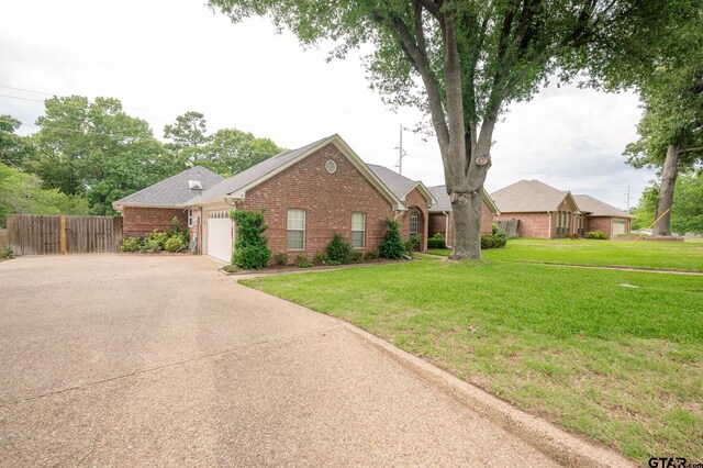 5607 Bostick Dr, Tyler, TX 75707 - single story home featuring brick siding, a garage, and concrete driveway