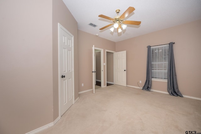 5607 Bostick Dr, Tyler, TX 75707 - unfurnished bedroom featuring light colored carpet, baseboards, and ceiling fan