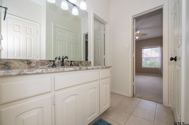 5607 Bostick Dr, Tyler, TX 75707 - bathroom with tile patterned floors, vanity, baseboards, and a ceiling fan