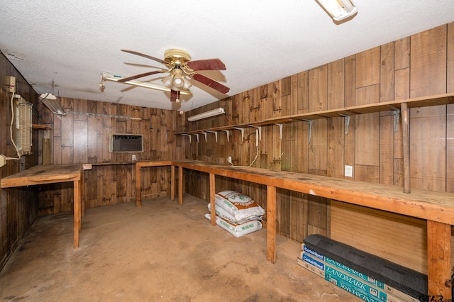 5607 Bostick Dr, Tyler, TX 75707 - below grade area with wooden walls, a ceiling fan, a textured ceiling, and an AC wall unit