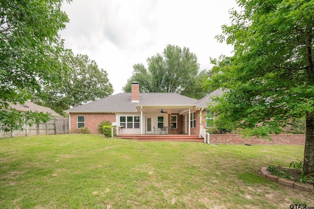 5607 Bostick Dr, Tyler, TX 75707 - rear view of house with a ceiling fan, brick siding, a chimney, and a deck