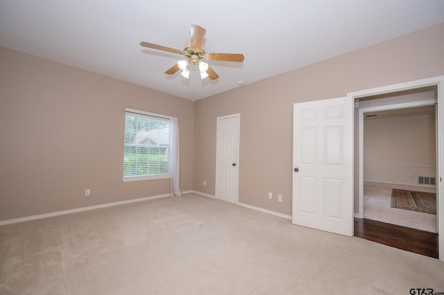 5607 Bostick Dr, Tyler, TX 75707 - unfurnished bedroom featuring light carpet, baseboards, and a ceiling fan