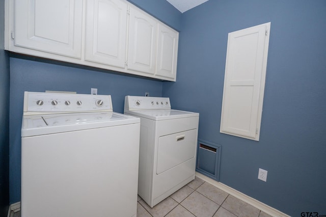 5607 Bostick Dr, Tyler, TX 75707 - laundry area with washer and dryer, cabinet space, light tile patterned flooring, and baseboards