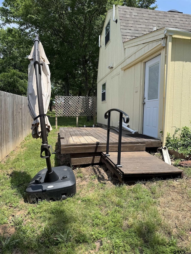 wooden deck with fence and a lawn
