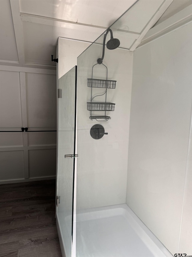 bathroom with wood finished floors and a shower