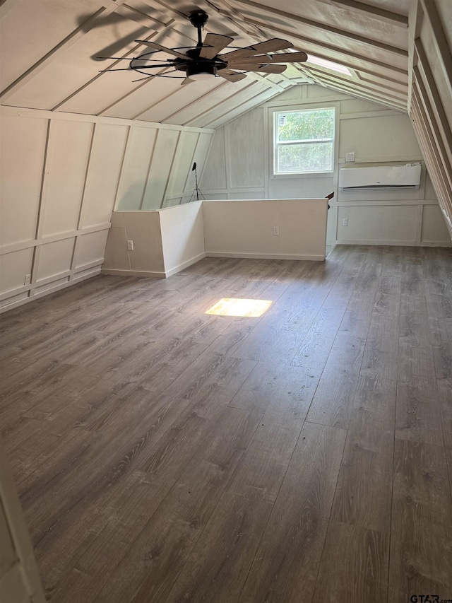 bonus room with a ceiling fan, vaulted ceiling, and dark wood finished floors