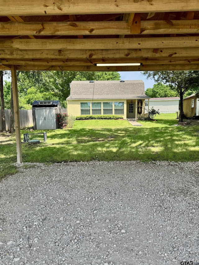 view of front of property with an outbuilding, a front lawn, and fence