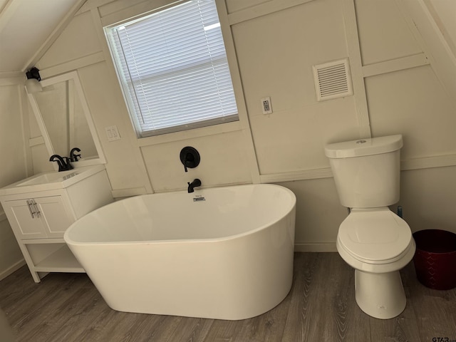 full bathroom with toilet, visible vents, a soaking tub, and wood finished floors