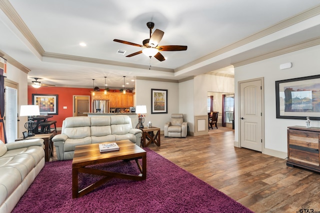2921 W Alamosa Dr, Terrell, TX 75160 - living area featuring a raised ceiling, ceiling fan, wood finished floors, crown molding, and recessed lighting