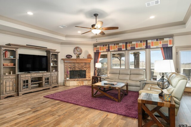 2921 W Alamosa Dr, Terrell, TX 75160 - living room featuring a tray ceiling, ceiling fan, ornamental molding, wood finished floors, and recessed lighting
