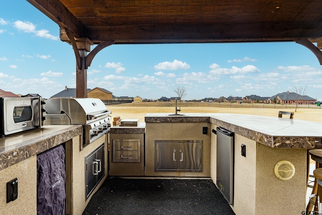 2921 W Alamosa Dr, Terrell, TX 75160 - view of patio with a grill, exterior kitchen, and a residential view