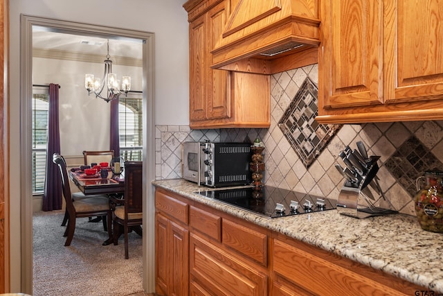 2921 W Alamosa Dr, Terrell, TX 75160 - kitchen with black electric cooktop, custom exhaust hood, a chandelier, crown molding, and carpet floors