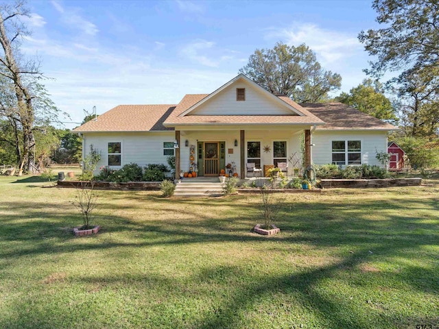 view of front facade featuring covered porch and a front yard