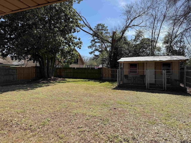 view of yard with an outdoor structure and a fenced backyard