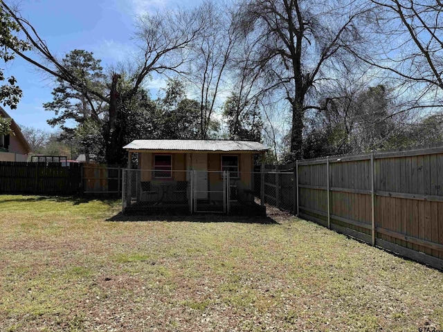 view of yard with an outdoor structure and a fenced backyard