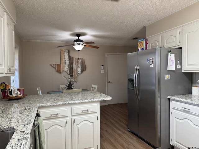 kitchen featuring stainless steel refrigerator with ice dispenser, wood finished floors, a peninsula, light countertops, and ceiling fan