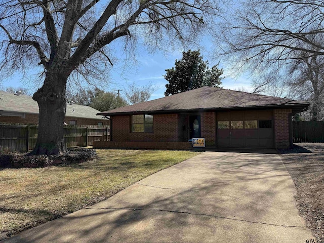 single story home with brick siding, an attached garage, concrete driveway, and fence