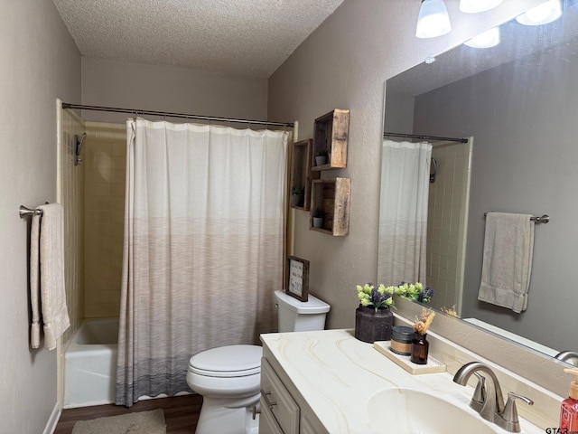 full bathroom featuring vanity, wood finished floors, shower / bath combo, a textured ceiling, and toilet