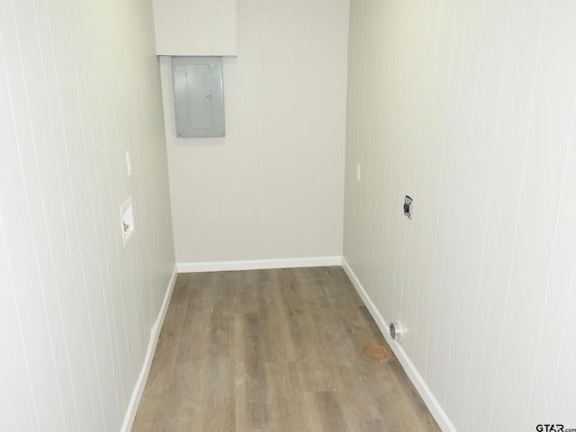 interior space with electric panel, electric dryer hookup, and hardwood / wood-style flooring