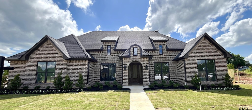 20216 Roebuck Dr, Bullard, TX 75757 - french country home with brick siding, a front yard, and a shingled roof
