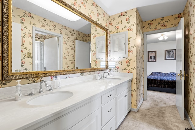 1901 Livingston St, Longview, TX 75601 - ensuite bathroom with wallpapered walls, double vanity, and baseboards