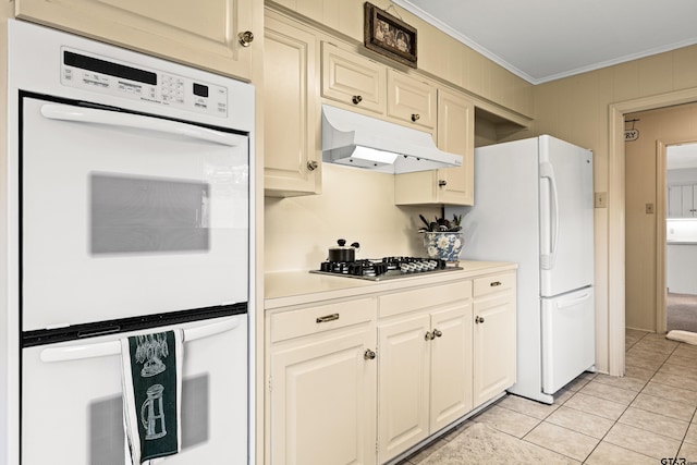 1901 Livingston St, Longview, TX 75601 - kitchen with under cabinet range hood, white appliances, ornamental molding, light tile patterned floors, and light countertops
