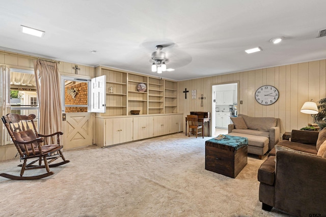 1901 Livingston St, Longview, TX 75601 - living area with light colored carpet, a ceiling fan, and wooden walls